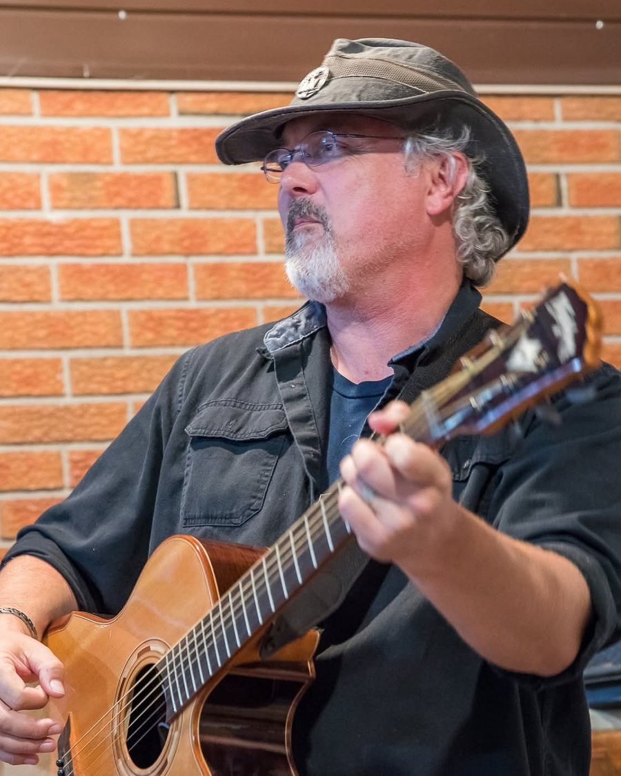 Mark McKechnie performing live with acoustic guitar